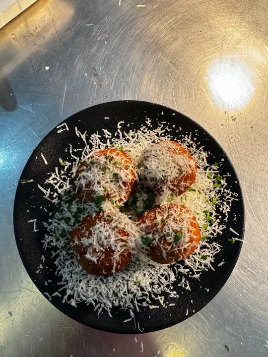 Mushroom arancini under grated parmesan